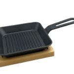 Cast iron squared sizzling platter with wooden board